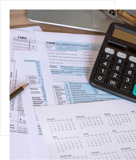 Tax forms and calculator on desk